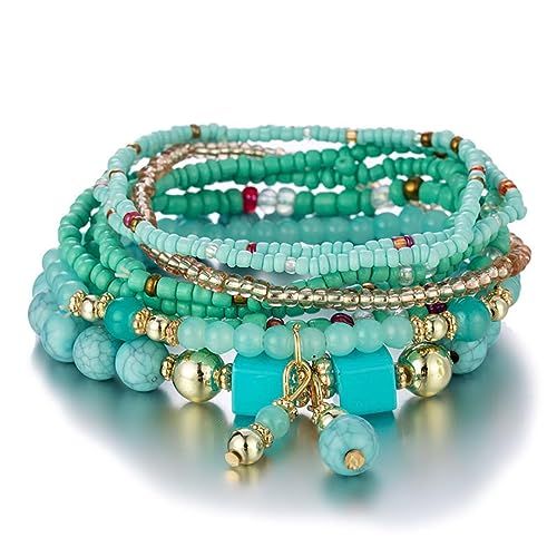 Bracelet fantaisie multicouche pour femme, perles et pompons, accessoire tendance, adaptable à tous les styles et occasions, polyvalent et élégant.